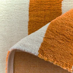 Indoor rug with ochre and white stripes