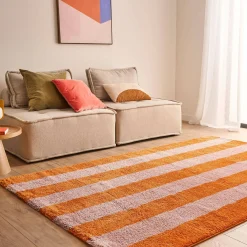Indoor rug with orange and pink stripes