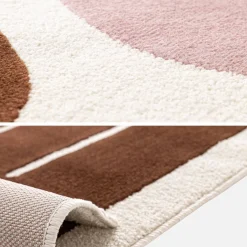Indoor rug with pink and brown graphic pattern