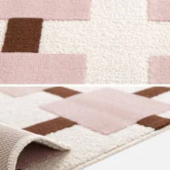 Indoor rug with pink and brown checkered pattern