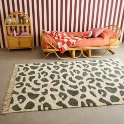Interior cotton rug with dark green speckled pattern and fringes