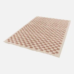 Old pink and cream checkerboard interior rug