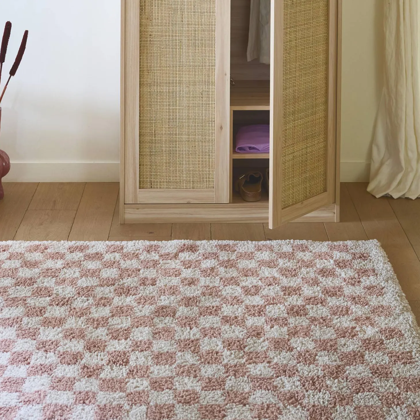 Old pink and cream checkerboard interior rug
