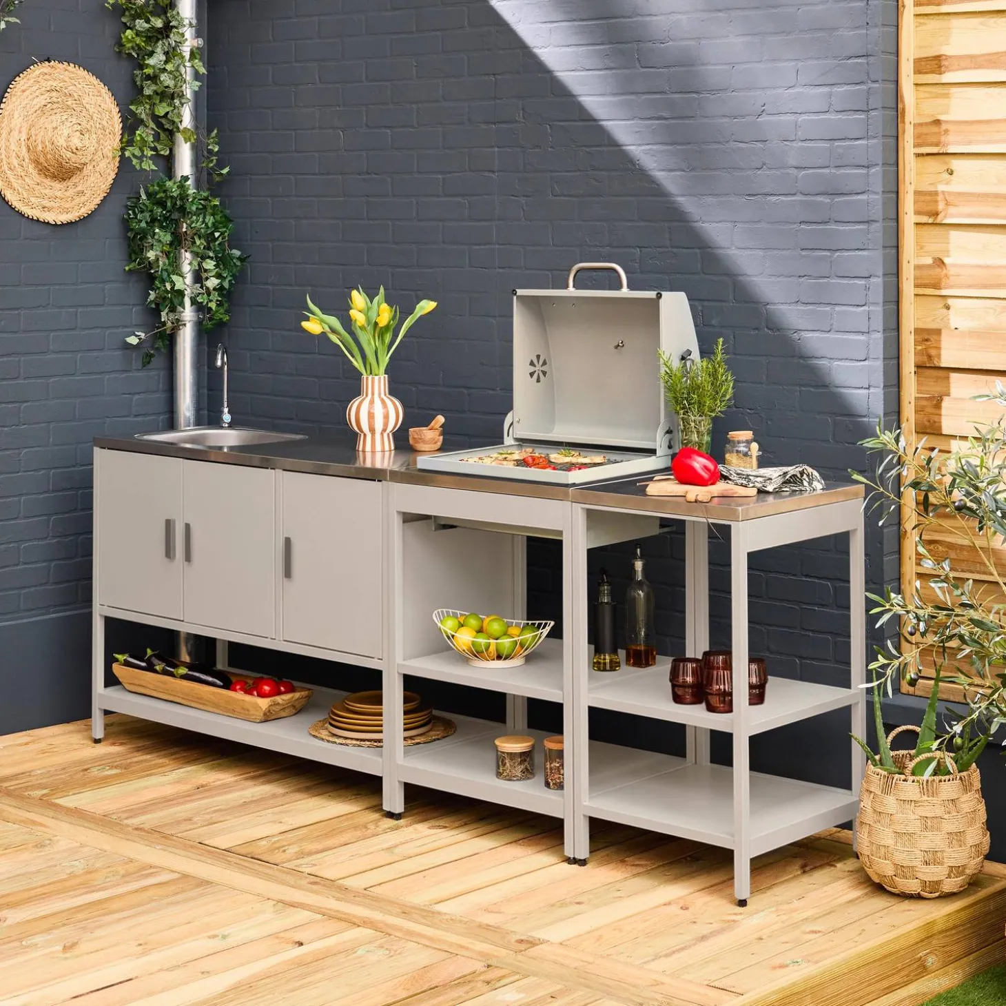 Outdoor kitchen with charcoal barbecue and 3 modules with sink