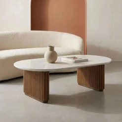 Oval coffee table in rubberwood with stone effect veneer