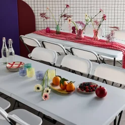 Pair of folding plastic reception tables with 12 chairs