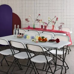Pair of folding plastic reception tables with 12 chairs