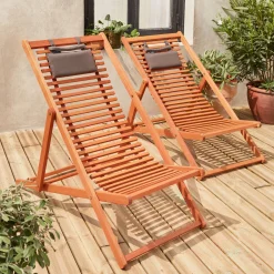Pair of slatted wooden deck chairs
