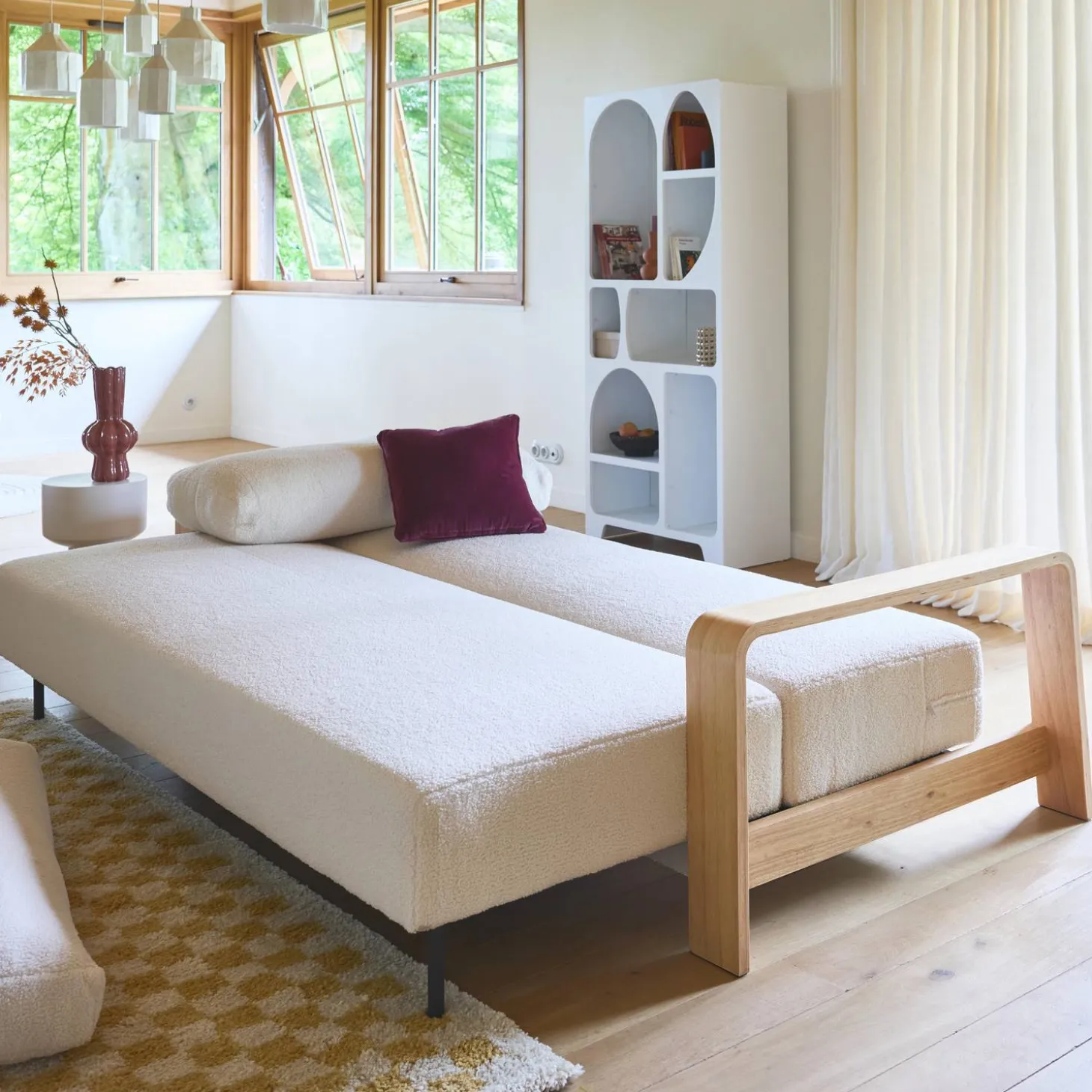 3-seater sofa bed in white boucle with wooden armrests