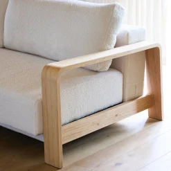 3-seater sofa bed in white boucle with wooden armrests