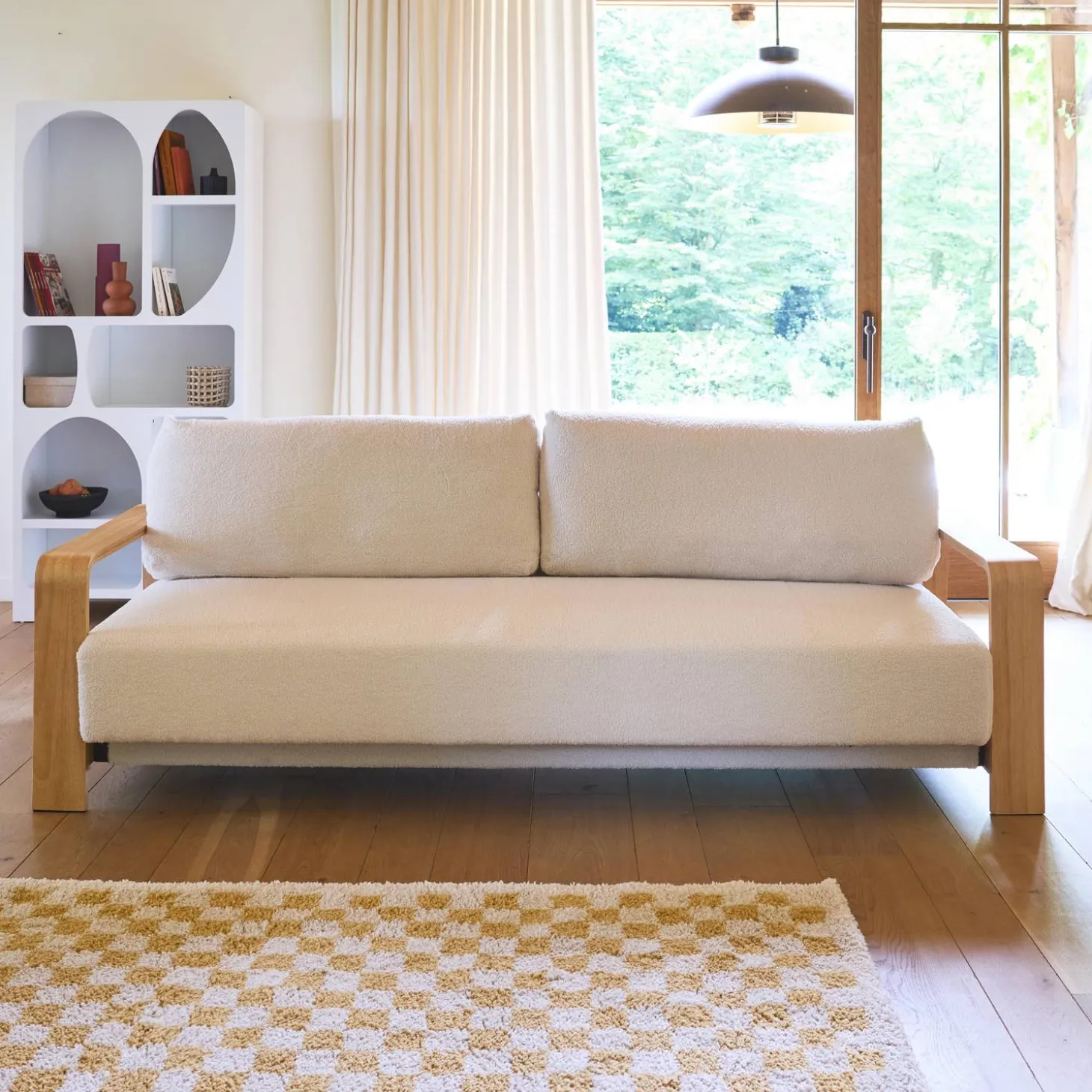 3-seater sofa bed in white boucle with wooden armrests