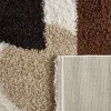 Shaggy indoor rug with circular patterns in beige, brown, black