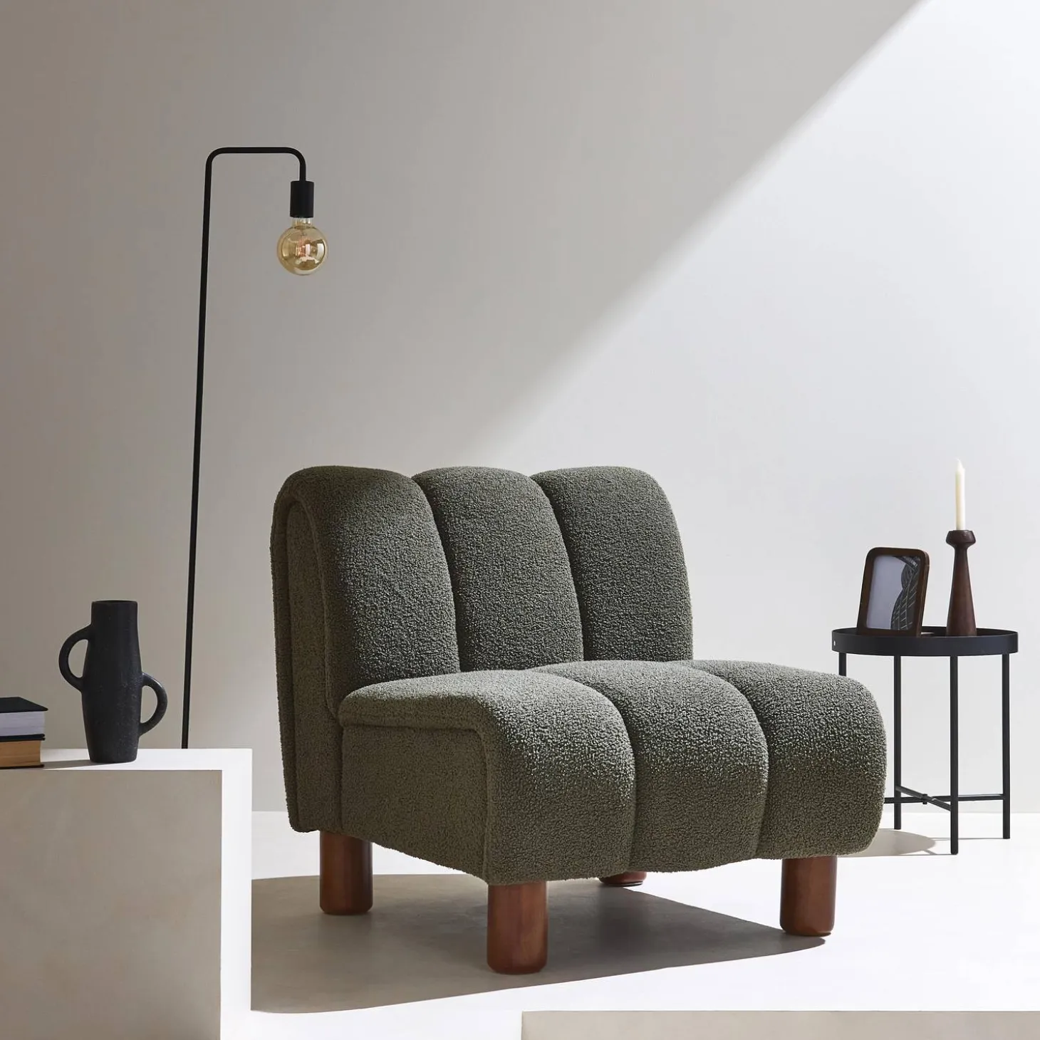 Wooden armchair with rounded legs in boucle fabric